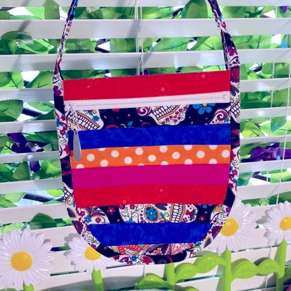 Crossbody pouch with bright sugar skulls and polka dots